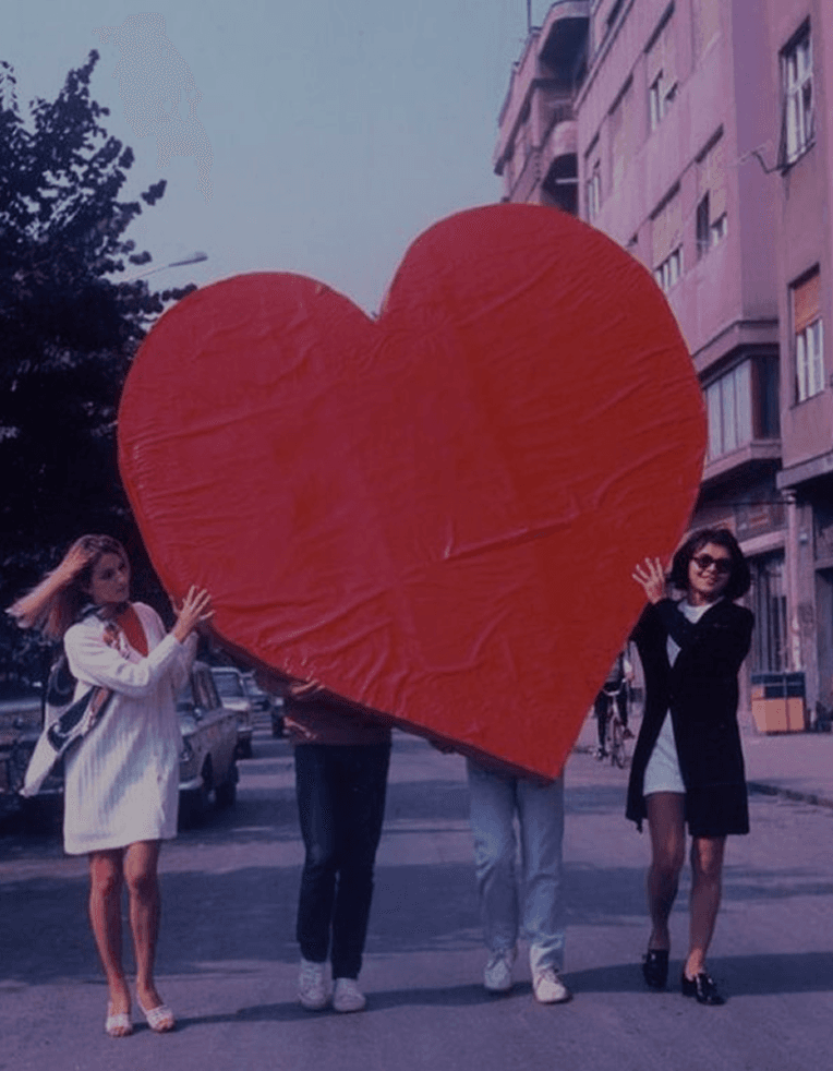 People holding large red heart with how it works text
